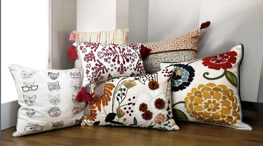 Handcrafted embroidered throw pillows styled in a cozy living room. The artisan-made pillows add a boho-inspired touch to the decor, enhancing the room's warm and inviting atmosphere with unique design and cultural craftsmanship.