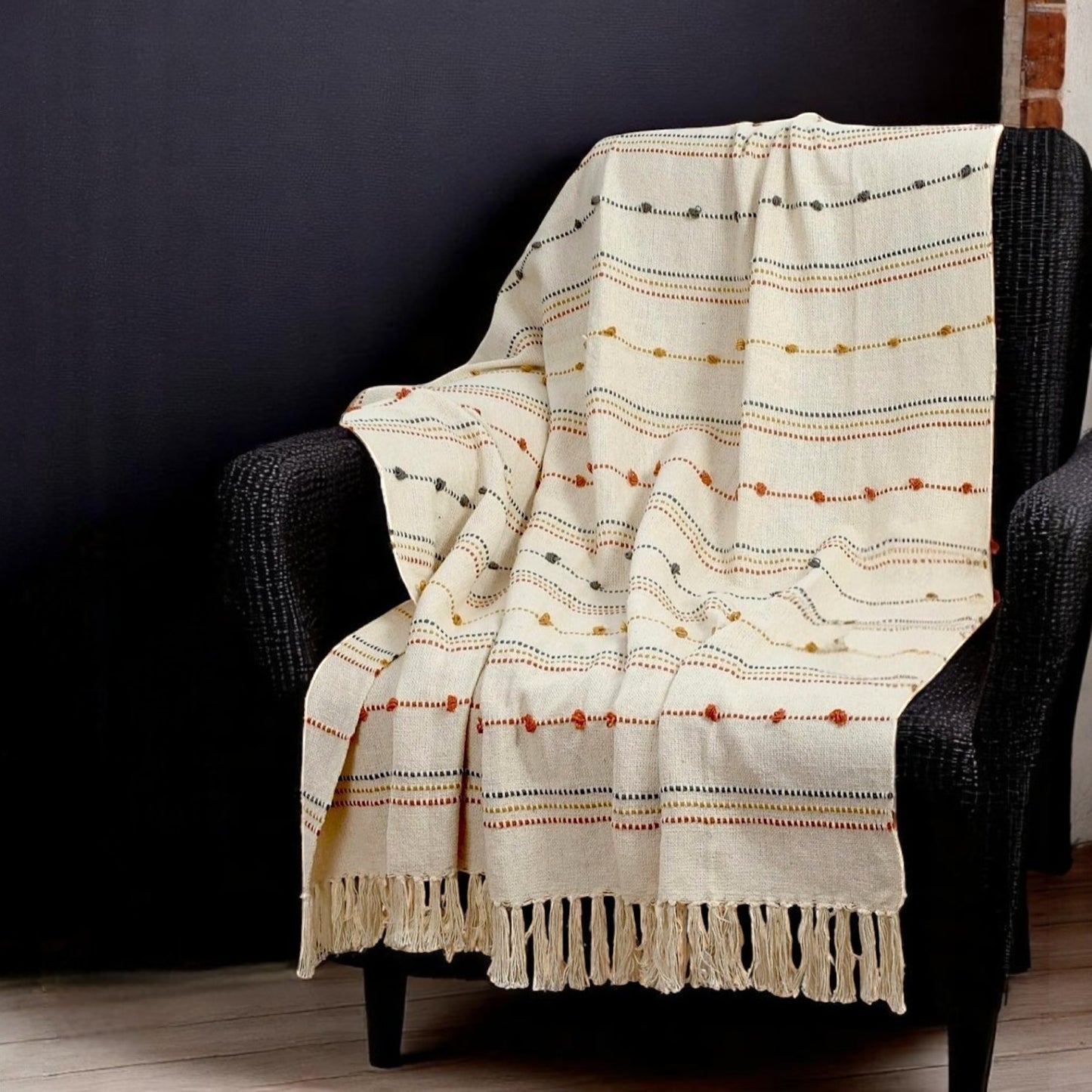 Cotton Multicolored Throw With Tassels square on a black rattan chair