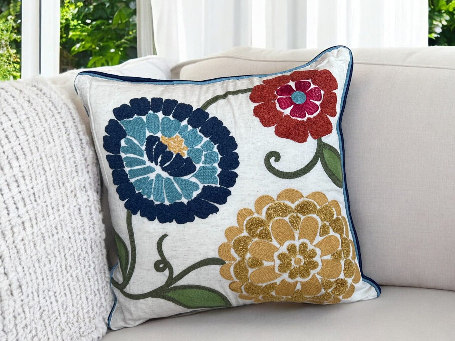 Artisan-made decorative pillow with detailed embroidery in neutral tones