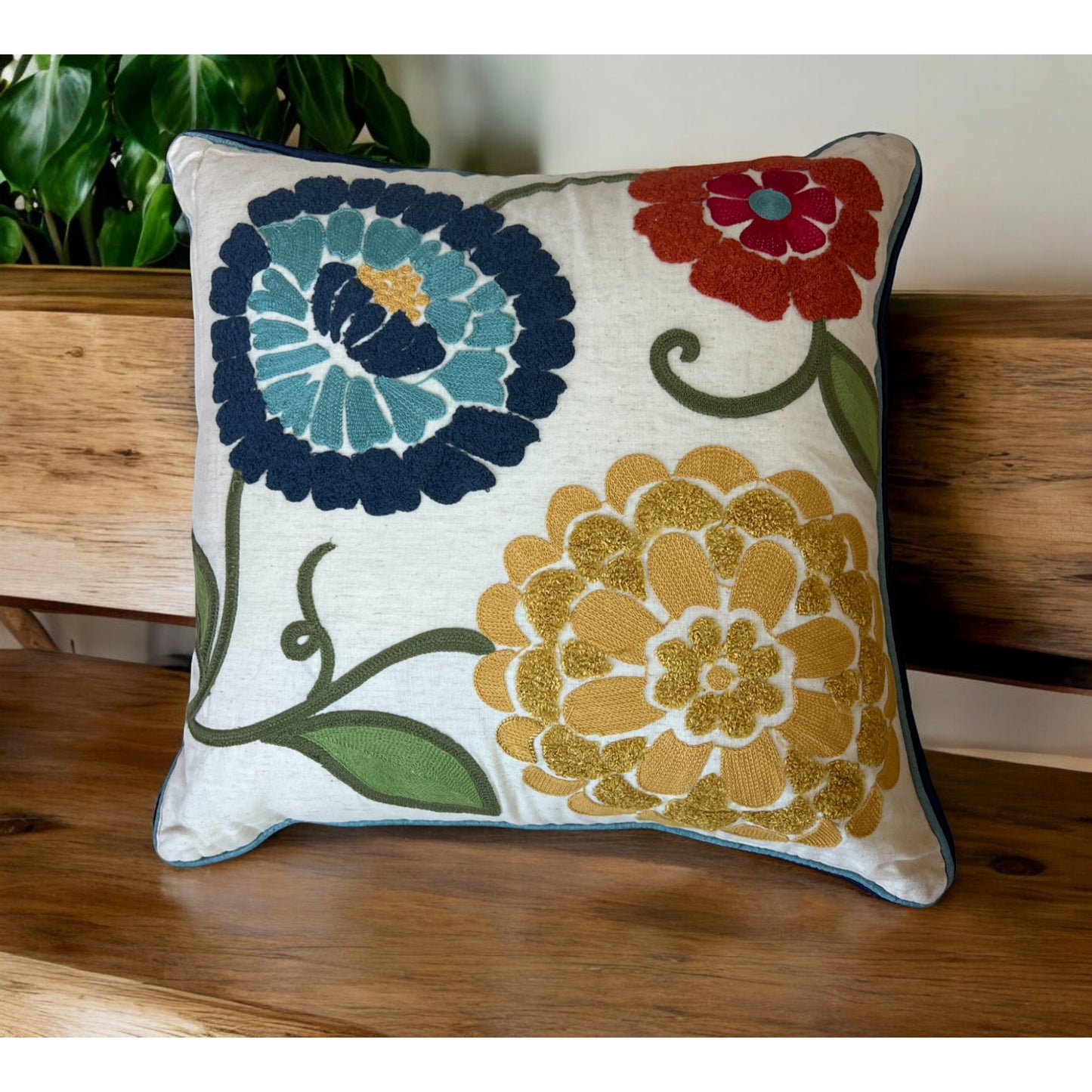 Decorative pillow with floral patterns on a wooden surface
