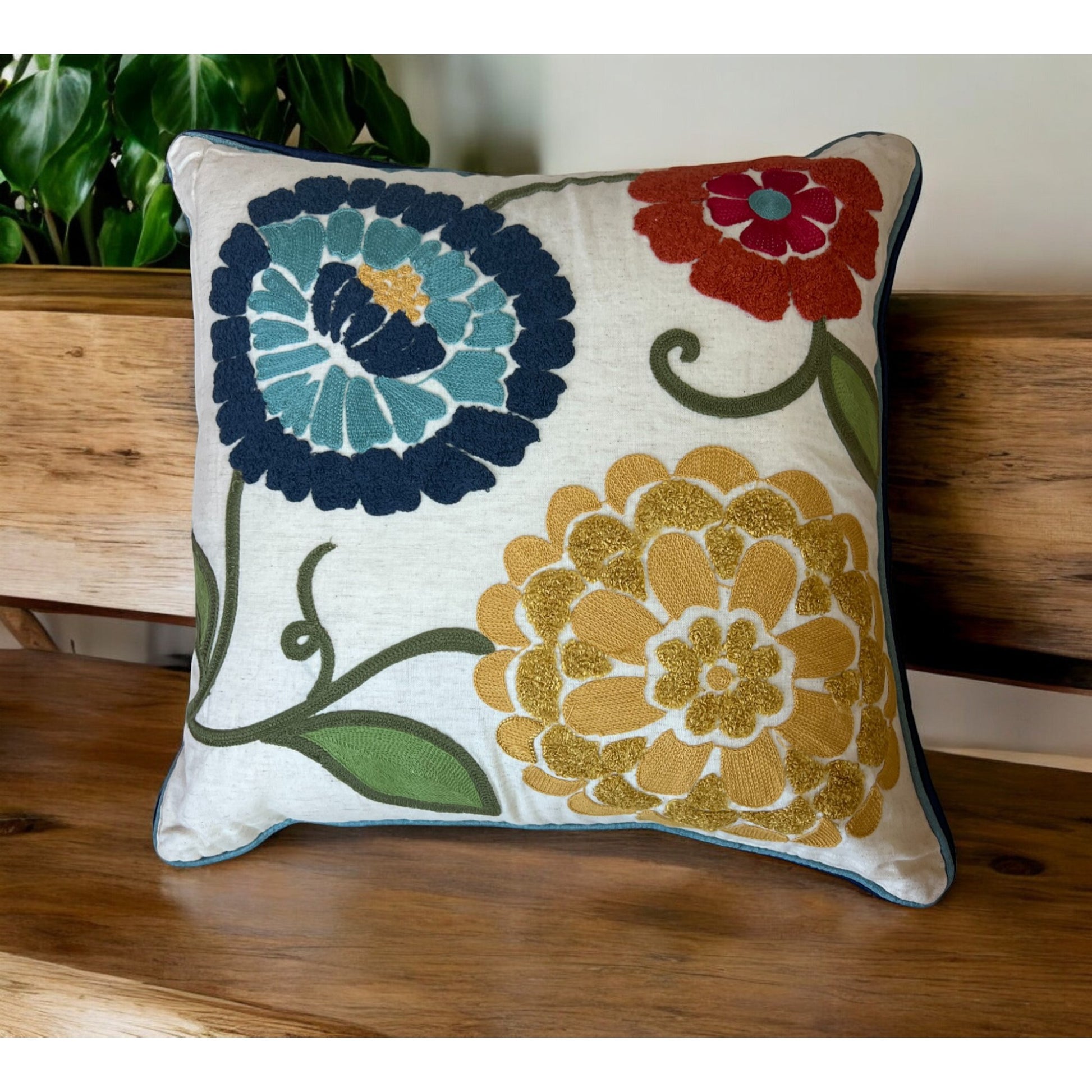 Decorative pillow with floral patterns on a wooden surface
